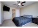 Bedroom features a TV, neutral paint, and a fan at 12218 S Oak Bluff Trl, Parker, CO 80134