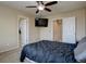 Bedroom with a ceiling fan, TV, and neutral-colored walls offers a cozy retreat at 12218 S Oak Bluff Trl, Parker, CO 80134