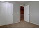 Bedroom with carpet, closet, and open door providing a glimpse of the upstairs hallway at 12218 S Oak Bluff Trl, Parker, CO 80134