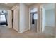 Hallway with doors leading to bedrooms and closets, showcasing the home's layout at 12218 S Oak Bluff Trl, Parker, CO 80134