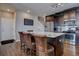 A view of the kitchen island shows the open layout with custom cabinets, granite counters, and stainless appliances at 12218 S Oak Bluff Trl, Parker, CO 80134