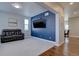 Stylish living room with carpet, large windows, and a navy blue accent wall for a modern touch at 12218 S Oak Bluff Trl, Parker, CO 80134