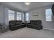 Comfortable living room with neutral carpet, large windows, and plenty of natural light at 12218 S Oak Bluff Trl, Parker, CO 80134