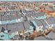 Aerial view of a community with colorful homes and well-maintained roofs stretching into the distance at 2212 Tamarac St, Denver, CO 80238