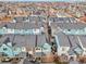 Wide aerial shot features rows of colorful homes with well-kept roofs in a planned community at 2212 Tamarac St, Denver, CO 80238