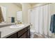 Well-lit bathroom features shower and bathtub combination, vanity, and a large mirror; perfect for daily routines at 2212 Tamarac St, Denver, CO 80238