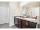 Bathroom featuring a double sink vanity with dark wood cabinetry and modern fixtures at 2212 Tamarac St, Denver, CO 80238