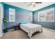 Bright bedroom featuring two-tone walls, a ceiling fan, and multiple windows at 2212 Tamarac St, Denver, CO 80238