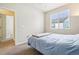 Serene bedroom with a large window offers views of the neighborhood and access to another room or a spacious closet at 2212 Tamarac St, Denver, CO 80238