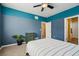 Spacious bedroom with a striped bedspread, a window, and doorways to other rooms at 2212 Tamarac St, Denver, CO 80238