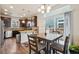 Dining area with a square table, hardwood floors, and natural light at 2212 Tamarac St, Denver, CO 80238