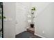 Bright entryway with a white front door, staircase, and a decorative plant at 2212 Tamarac St, Denver, CO 80238