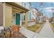 Exterior view of a two-story home with a teal-colored front door and fenced yard at 2212 Tamarac St, Denver, CO 80238