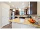 Well-lit kitchen featuring granite countertops, stainless steel appliances and dark wood cabinetry at 2212 Tamarac St, Denver, CO 80238