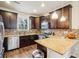 Modern kitchen with stainless steel appliances, granite countertops, and dark wood cabinets at 2212 Tamarac St, Denver, CO 80238