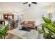 Open-concept living room and dining area with hardwood floors and natural light at 2212 Tamarac St, Denver, CO 80238