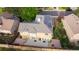 Aerial view of a home with solar panels on the roof and a patio with both paved and deck space at 7627 Halleys Dr, Littleton, CO 80125