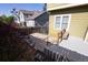 A view of the backyard, featuring a stone patio with a wooden bench and stairs at 7627 Halleys Dr, Littleton, CO 80125
