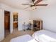 Bedroom features a ceiling fan, a desk, and two twin beds at 7627 Halleys Dr, Littleton, CO 80125