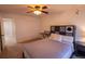 Spacious bedroom features neutral carpet, a queen bed, and an ensuite bathroom at 7627 Halleys Dr, Littleton, CO 80125