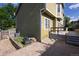 A view of the exterior of the home featuring a stone patio and deck at 7627 Halleys Dr, Littleton, CO 80125