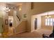 Spacious foyer with high ceilings, hardwood floors, staircase, and views into the living and dining areas at 7627 Halleys Dr, Littleton, CO 80125