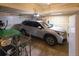 Garage features a car, a fridge, shelving units, and lots of extra storage at 7627 Halleys Dr, Littleton, CO 80125