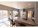 Bright kitchen features granite countertops, stainless steel appliances, barstool seating, and sliding glass door to the yard at 7627 Halleys Dr, Littleton, CO 80125