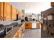 Modern kitchen features wood cabinets, stainless steel appliances, granite counters, and an eat-in bar at 7627 Halleys Dr, Littleton, CO 80125