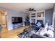 The living room features a fireplace, built-in shelving, hardwood floors, and comfortable seating at 7627 Halleys Dr, Littleton, CO 80125