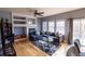 Cozy living room boasts a fireplace with built-ins, a ceiling fan, multiple windows, and access to outdoor space at 7627 Halleys Dr, Littleton, CO 80125