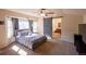 Spacious main bedroom with a sliding barn door to ensuite bathroom, ceiling fan, and carpet floors at 7627 Halleys Dr, Littleton, CO 80125