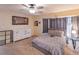 Bright bedroom featuring carpet floors, a ceiling fan, and a comfortable bed set at 7627 Halleys Dr, Littleton, CO 80125