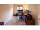 Office space with neutral carpet, one window for natural light, and a desk setup at 7627 Halleys Dr, Littleton, CO 80125