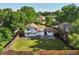 An aerial view of a home with a spacious backyard, lawn, and back patio at 9591 W Florida Pl, Lakewood, CO 80232