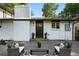 Back patio featuring comfortable outdoor seating, painted brick, and mature shade trees at 9591 W Florida Pl, Lakewood, CO 80232