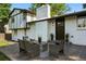 Back patio with outdoor seating, painted brick, and mature shade trees at 9591 W Florida Pl, Lakewood, CO 80232