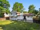 Aerial view of large backyard with manicured lawn and back patio with outdoor seating at 9591 W Florida Pl, Lakewood, CO 80232