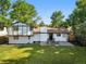 Aerial view of backyard featuring a manicured lawn and back patio with outdoor seating at 9591 W Florida Pl, Lakewood, CO 80232