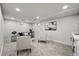 Finished basement features neutral carpet, recessed lighting, and a comfortable seating area at 9591 W Florida Pl, Lakewood, CO 80232