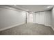 Finished basement with neutral carpet, white walls, trim, closet, and two interior doors at 9591 W Florida Pl, Lakewood, CO 80232