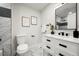 Well-lit bathroom featuring marble tile flooring, a modern vanity, and stylish black fixtures at 9591 W Florida Pl, Lakewood, CO 80232