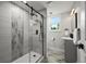 Bathroom featuring a glass shower with gray tile, vanity, and a modern sink at 9591 W Florida Pl, Lakewood, CO 80232