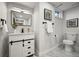 Bathroom features a marble floor, a modern vanity with black hardware, and sleek fixtures at 9591 W Florida Pl, Lakewood, CO 80232