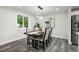 A modern dining room with a sleek table and chairs, and a minimalist light fixture at 9591 W Florida Pl, Lakewood, CO 80232