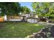 Charming two-story home boasts a well-manicured lawn and two-car garage at 9591 W Florida Pl, Lakewood, CO 80232