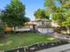 Charming two-story home boasts a well-manicured lawn and two-car garage at 9591 W Florida Pl, Lakewood, CO 80232