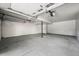 A spacious three car garage with finished white walls and sealed concrete floor at 9591 W Florida Pl, Lakewood, CO 80232