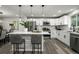 A well-lit, updated kitchen with white cabinets and stainless steel appliances at 9591 W Florida Pl, Lakewood, CO 80232