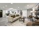 A bright living room featuring modern finishes and neutral decor, adjacent to staircase at 9591 W Florida Pl, Lakewood, CO 80232